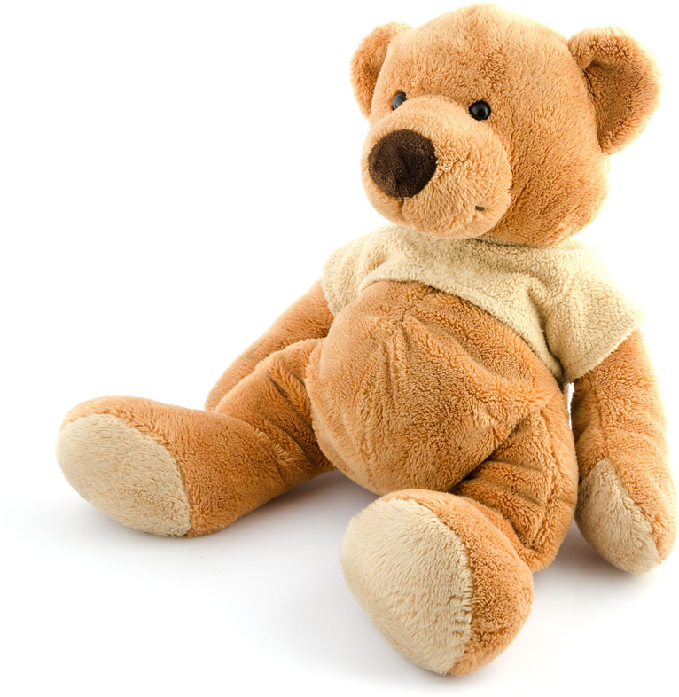 A brown teddy bear with a white shirt on.